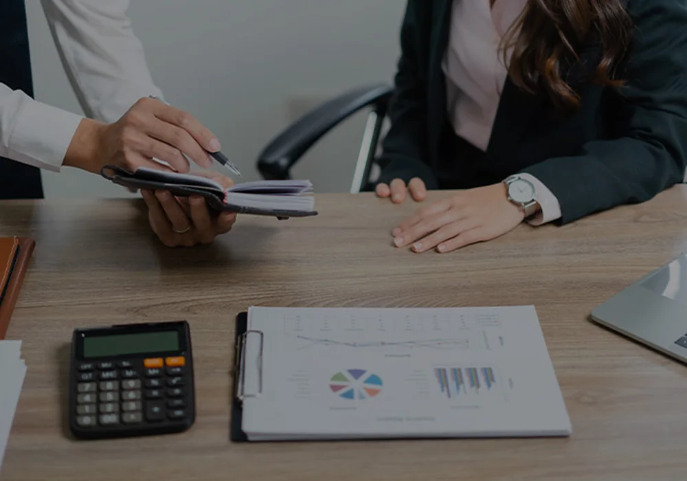 Business owners and financial adviser reviewing forecasts and strategic financial decisions